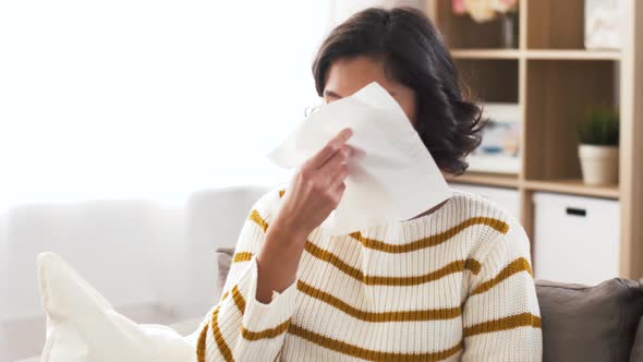 Sick Woman Blowing Nose in Paper Tissue at Home 1