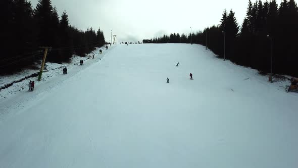 Aerial view of three skiers going down slope in Topolita Snow Summit.