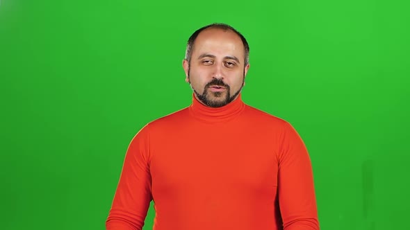 Full Caucasian Man Looking at Camera and Flirting Smiling. Green Screen. Slow Motion