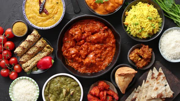 Assortment of Various Kinds of Indian Cousine on Dark Rusty Table