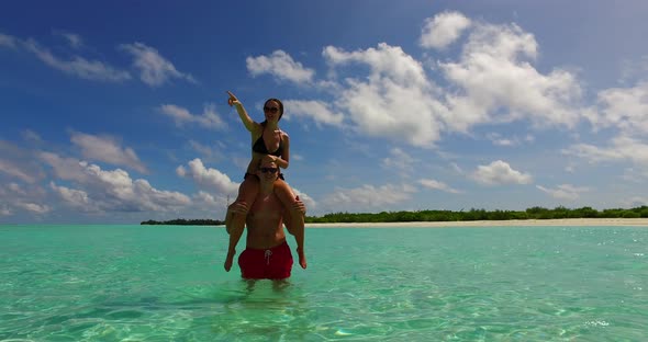 Young lady and man married on vacation enjoy life on beach on summer white sandy background 4K