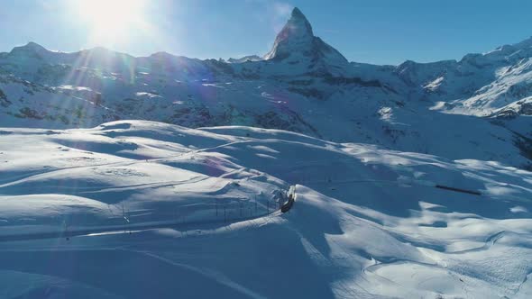 Matterhorn Mountain and Train in Sunny Winter Day. Swiss Alps. Switzerland. Aerial View