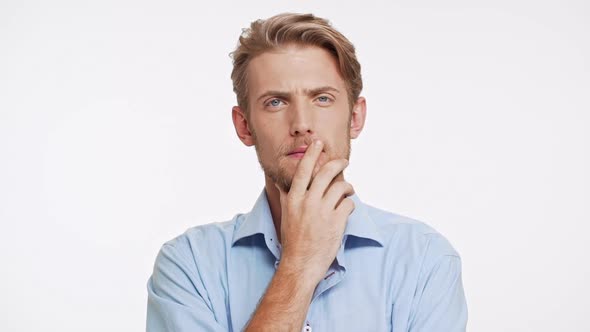 Unapproving Caucasian Male with Brown Beard and Blue Eyes on White Background in Slowmotion