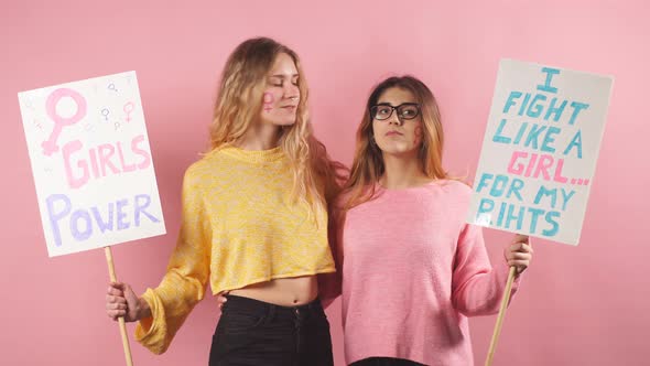 Two Slim Feminists Isolated Over Pink Background