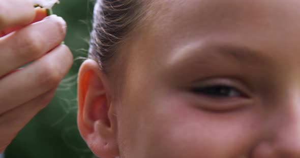 Mother putting flower in daughters hair