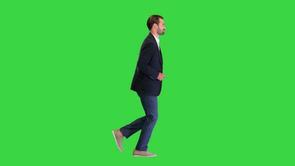 Handsome Running Businessman in a White Shirt and a Suit on a Green Screen Chroma Key