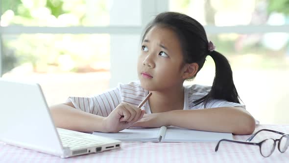 Beautiful Asian Girl Thinking And Writing To Notebook On The Table Slow Motion