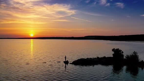 Flying over beautiful river. Aerial landscape flight over river against sunset