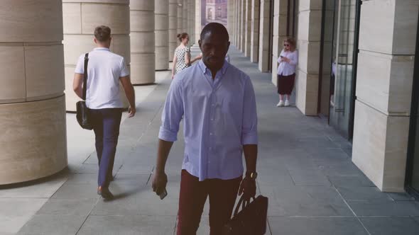 Tired Young Afroamerican Businessman Walking Outdoor Downtown