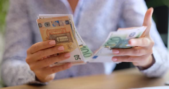 Woman Counts Money in Cash Euro Banknotes Closeup