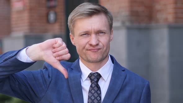 Thumbs Down by Businessman