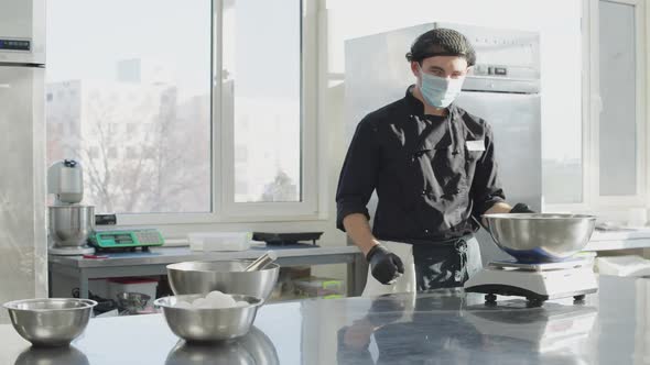 Confident Man in Coronavirus Face Mask Walking to Table in Kitchen and Thinking