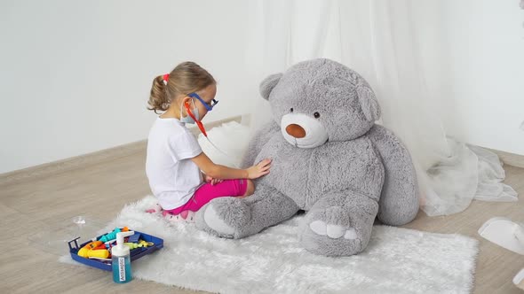 Child Playing Doctor Examine Toy Bear Patient