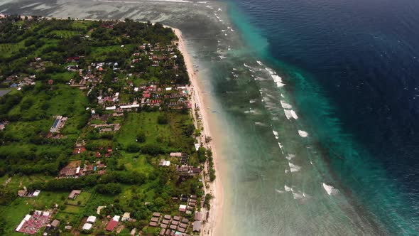 Aerial view of a beautiful coastline with the incoming waves