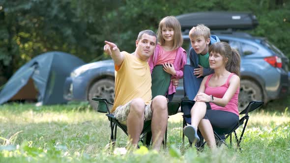 Parents and their children sitting together and chatting happily. Happy family enjoying time