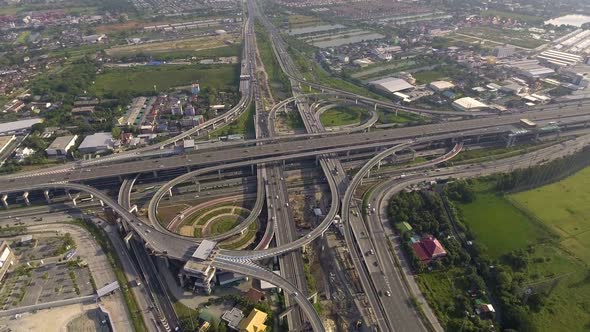 Aerial View of Highway Road Interchange with Busy Urban Traffic Speeding on Road