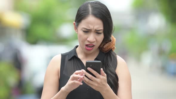 Young Beautiful Asian Businesswoman Using Phone in the Streets Outdoors