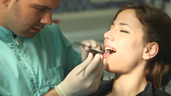 Little girl and dental assistant doing high-five after teeth checkup