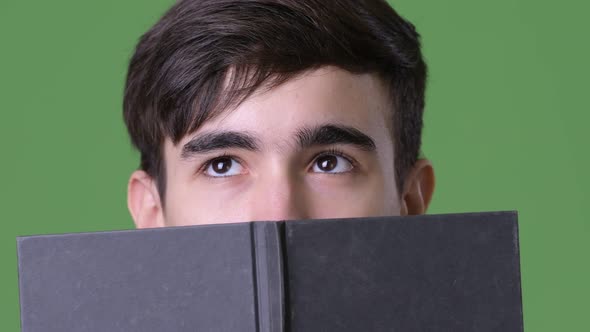 Young Handsome Iranian Teenage Boy Against Green Background