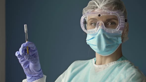 Portrait of a Young Nurse with a Syringe Ready to Vaccinate a Patient Against Covid 19