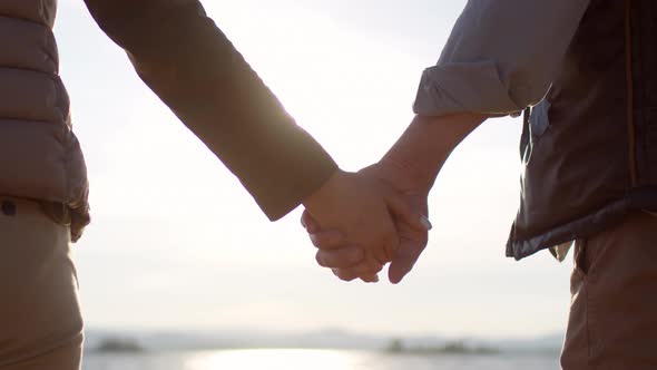 Couple Holding Hands at Sunset