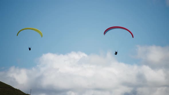 Two parachutists in the sky