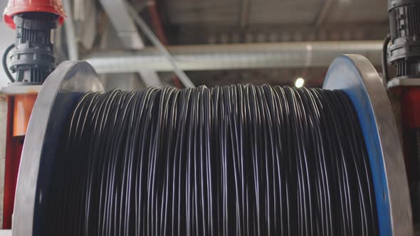 Spinning Reel with Cable in Cable Production Plant Closeup