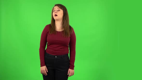 Funny Girl Is Smiling Broadly and Winking. Green Screen