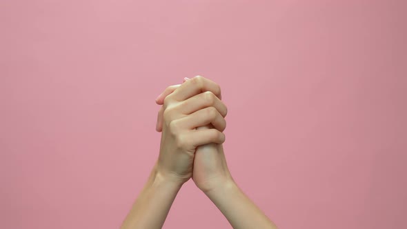 Close up of hand clapping on the pink background. celebration concept.