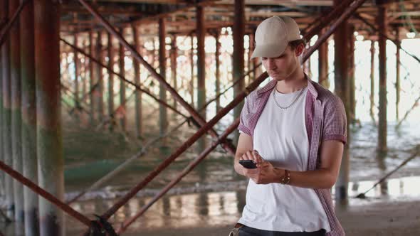 Man Making Purchase on His Smart Phone and Then Smiling To Camera