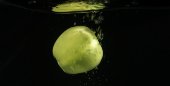 Green Apples Falling in Water Slow Motion