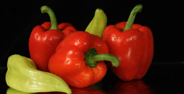 Red And Green Peppers On Black