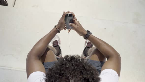 Top View of African American Man Using Modern Phone Outdoor