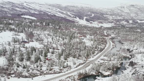 Countryside Road, River And Coniferous Forest Covered In Snow During Winter In Dovre, Innlandet Coun