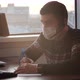 Caucasian Man Freelancer Wearing Medical Mask and Wired Headphones Working on Freelance From Home - VideoHive Item for Sale