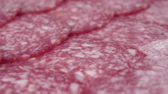 Freshly cut meat sausage is stacked in diagonal rows