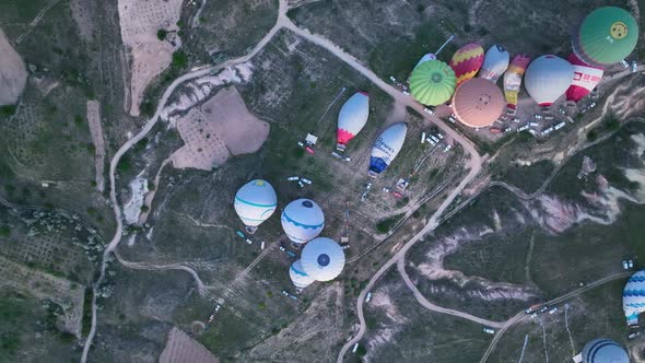 4K Aerial view of Goreme. Colorful hot air balloons fly over the valleys.