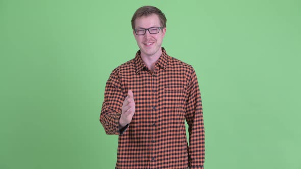 Happy Young Hipster Man Giving Handshake