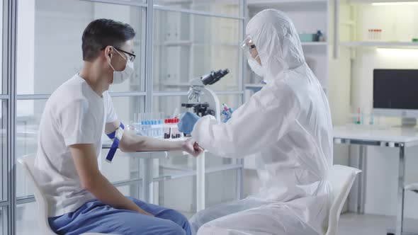 Doctor in Protective Suit Injecting Experimental Vaccine