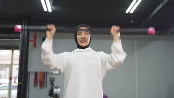 Arab Woman Trains in a White Sports Hijab