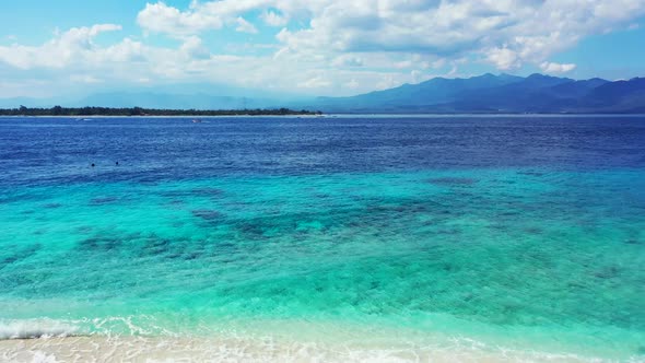 Aerial drone sky of marine island beach vacation by blue green lagoon and white sand background of a