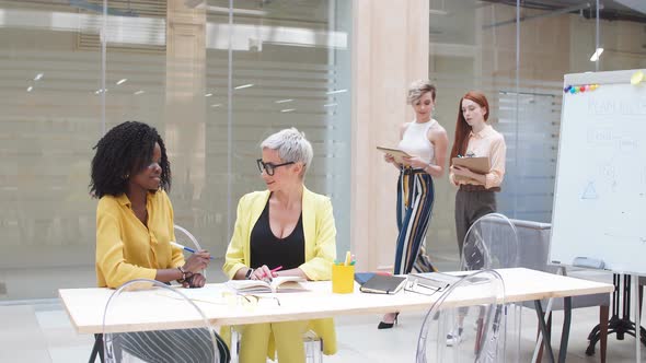 Happy Multiracial Businesswomen Having Discussion with Colleagues in Office