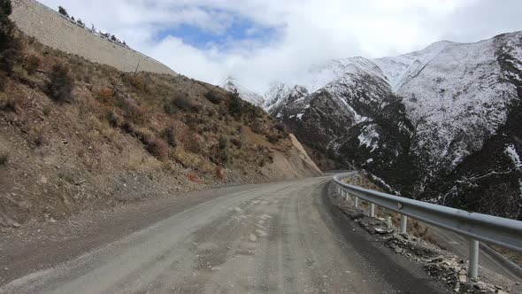 Off road car running on snowing mountain trail on winter day