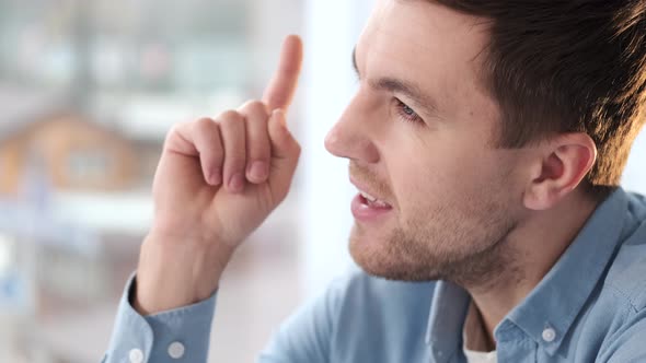 Man Found Excellent Idea Striked with Good Plan Raise Index Finger in Eureka Lightbulb Gesture