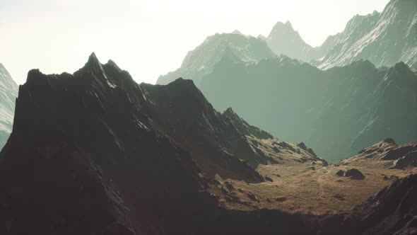 Rocks Covered with Grass Under a Cloudy Sky