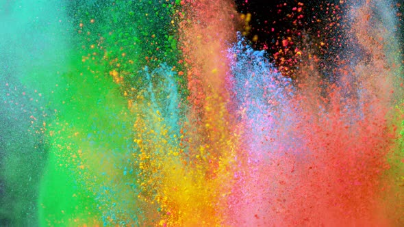Super Slowmotion Shot of Color Powder Explosions Isolated on Black Background alt