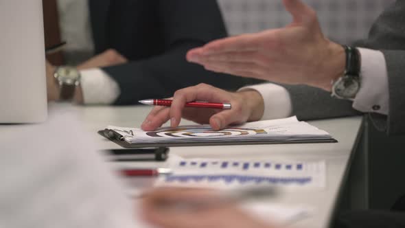 Gesticulating hands in meeting