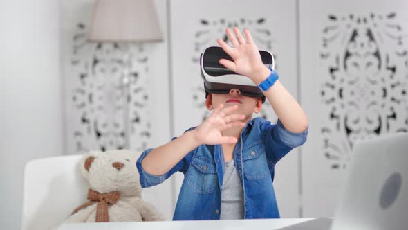 Enthusiastic Child Boy Wearing Virtual Reality Headset Making Gesturing Surrounded By Cyberspace