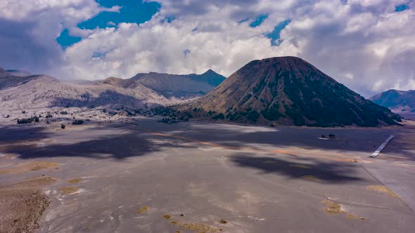 Aerial drone hyperlapse of clouds moving above an active volcano