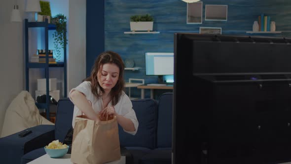 Young Woman Putting Bag of Takeaway Food on Table